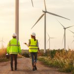 Power generating wind turbines on rolling hills of green spring wheat, Rio Vista, California