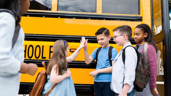 Children going back to school on a bus