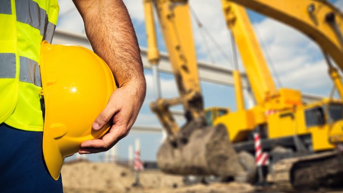 Construction worker and backhoe