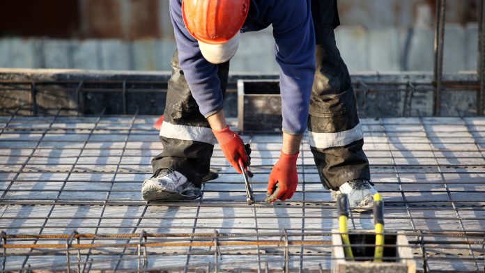 Worker at construction site with rebar