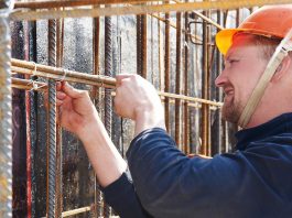 Construction worker tying rebar