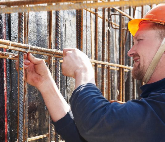 Construction worker tying rebar