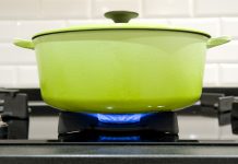 green cast iron cooking pot on a gas stove