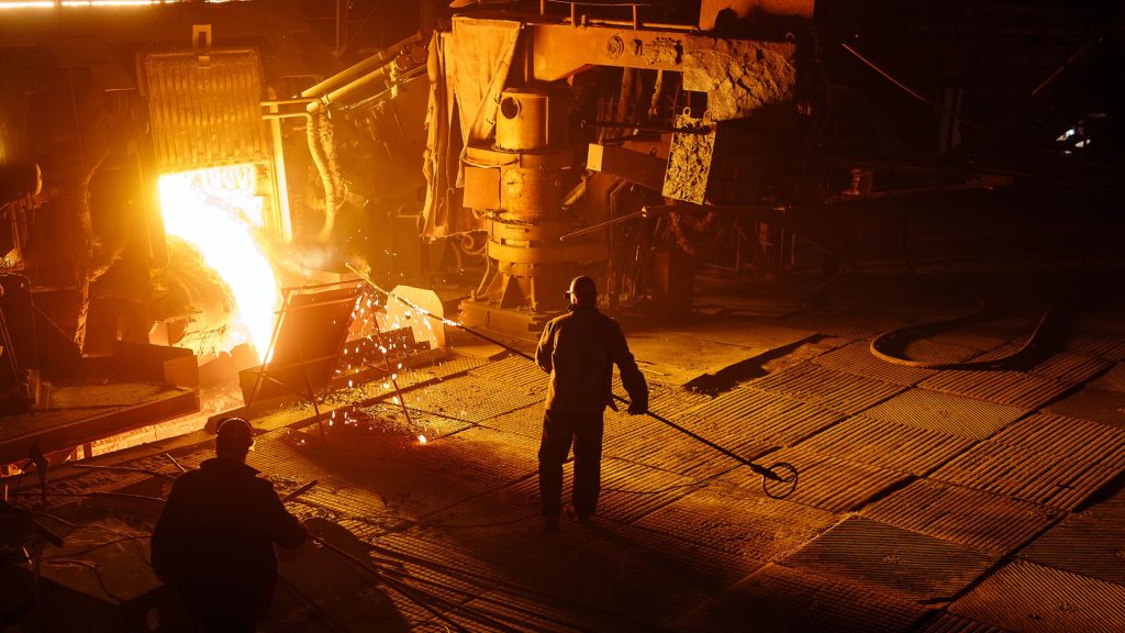 Steel mill worker over furnace