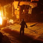 Steel mill worker over furnace