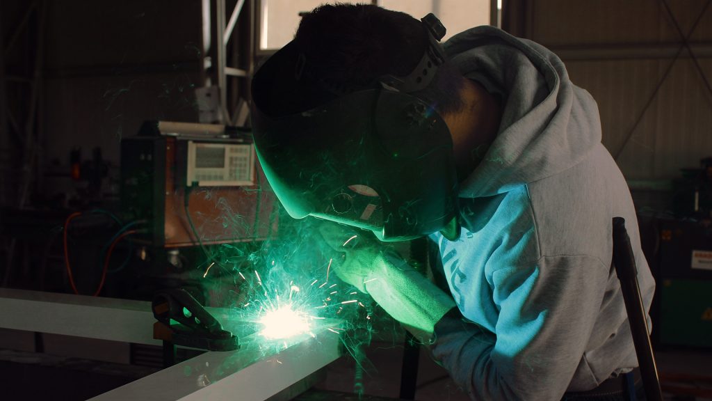 Welder in manufacturing facility