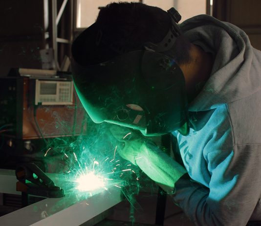 Welder in manufacturing facility