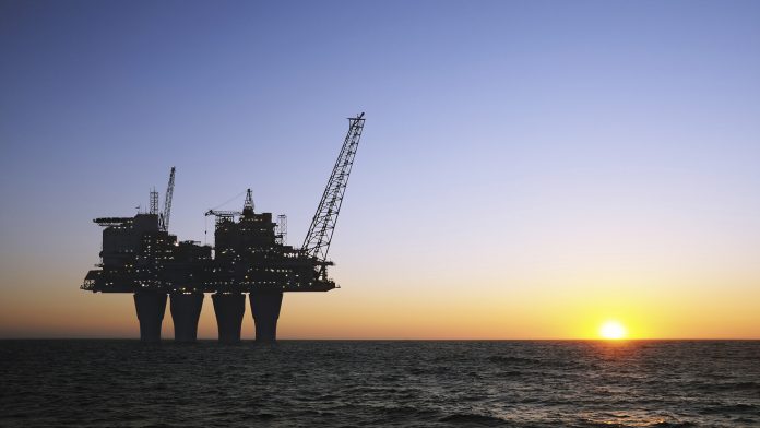 Offshore oil rig at sunset