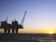 Offshore oil rig at sunset