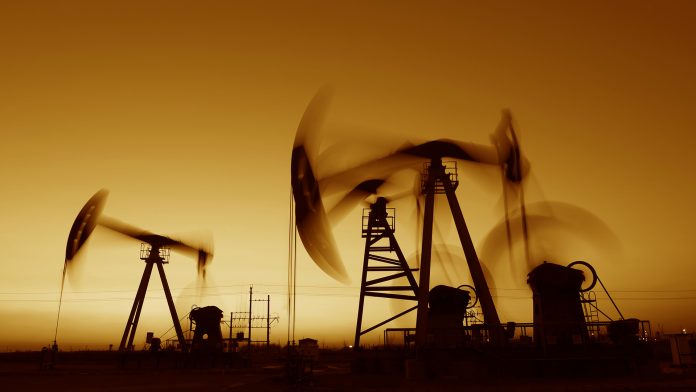 Oil derricks at sunset