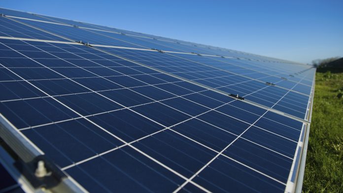 Row of solar panels on a solar farm