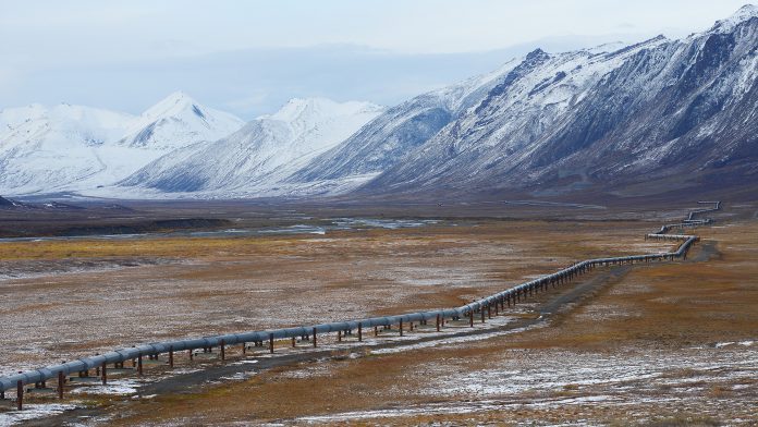 Oil pipeline in Alaska with mountain range