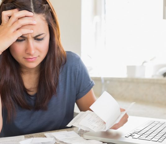 Woman looking at household bills