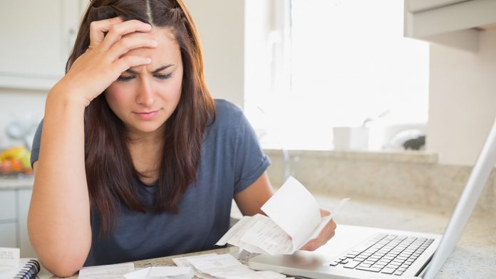 Woman looking at household bills