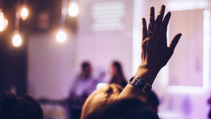 Woman raising hand to speak