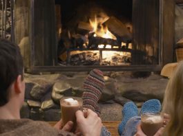 Couple relaxing by a fire