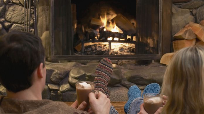 Couple relaxing by a fire