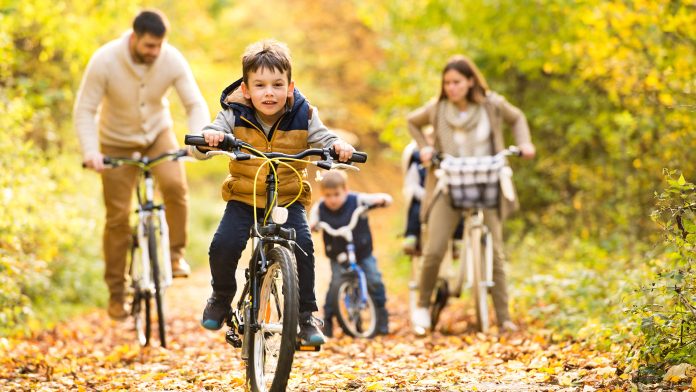 Family riding bikes in the woods