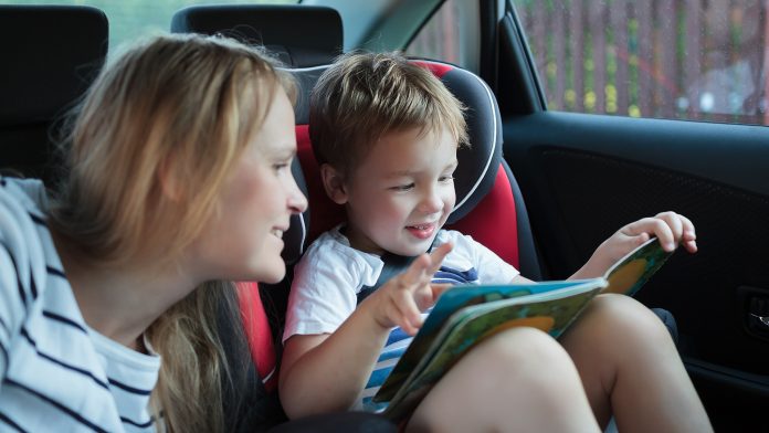 Mother and little son in the car reading