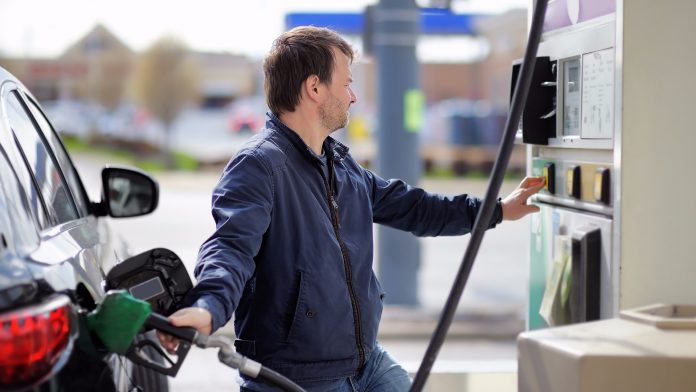 Man putting gas in car