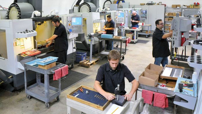 CNC machine shop with lathes, technicians and workers