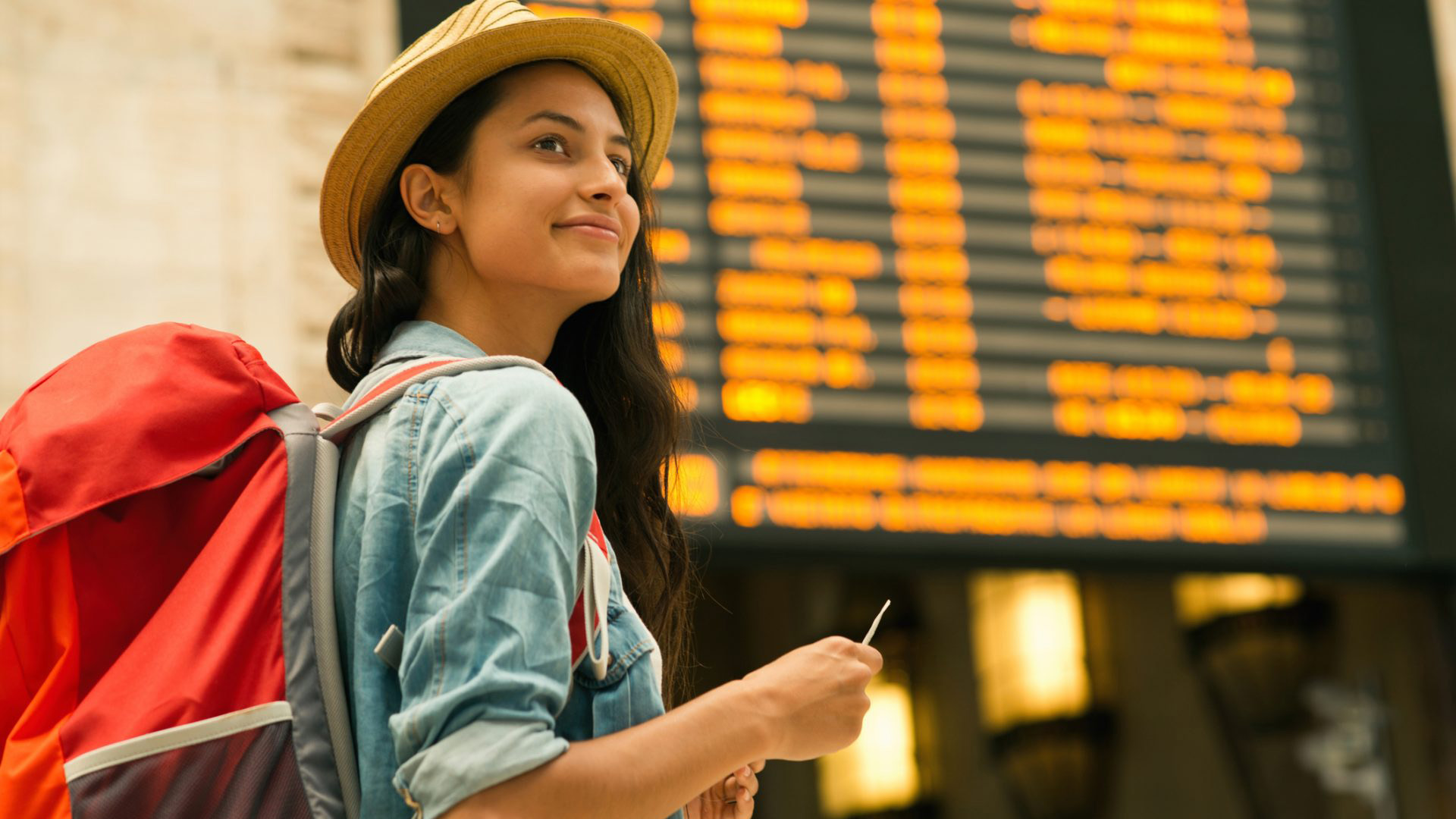 Young woman checking her train in time board