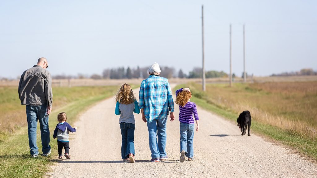 Family Walking Down Rural Gravel Driveway