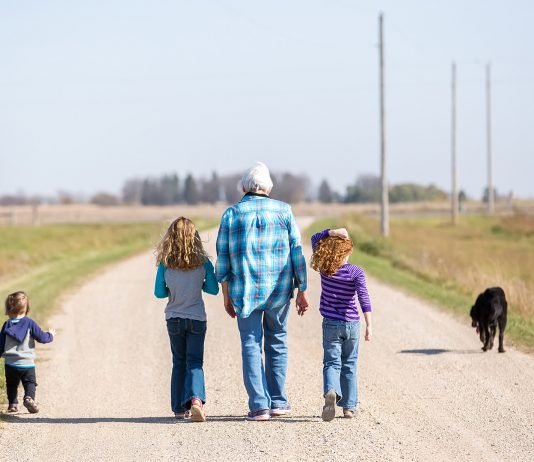 Family Walking Down Rural Gravel Driveway