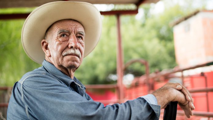 Older farmer on a tractor