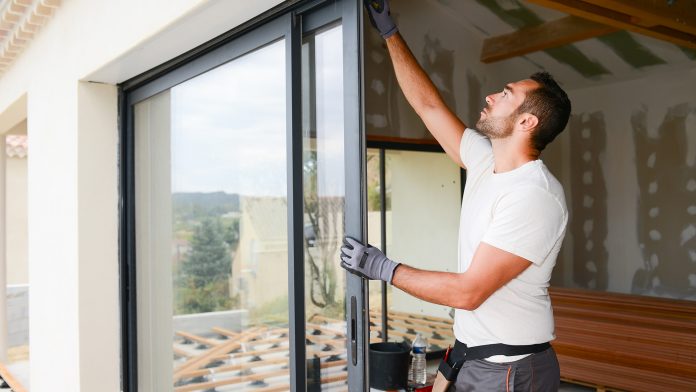 Worker installing a door