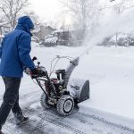 Man clearing snow with a snow blower