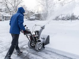 Man clearing snow with a snow blower