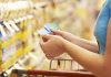 A woman checking her coupons in the store