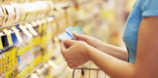 A woman checking her coupons in the store