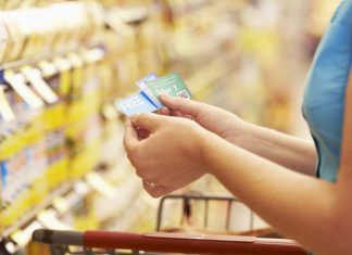 A woman checking her coupons in the store