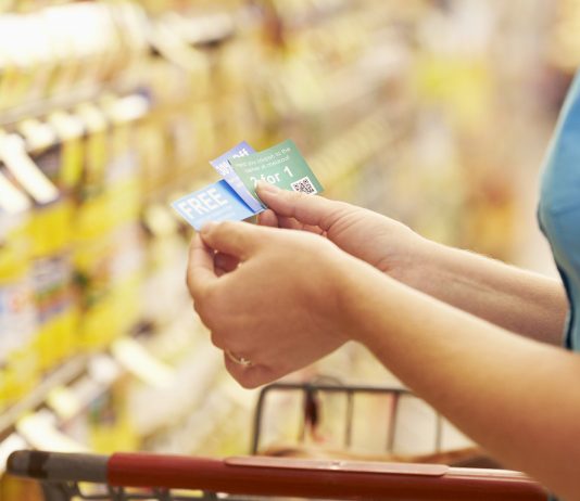 A woman checking her coupons in the store