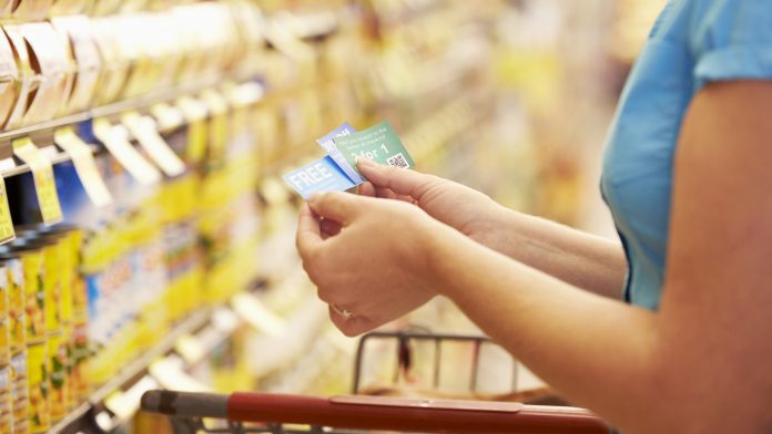 A woman checking her coupons in the store