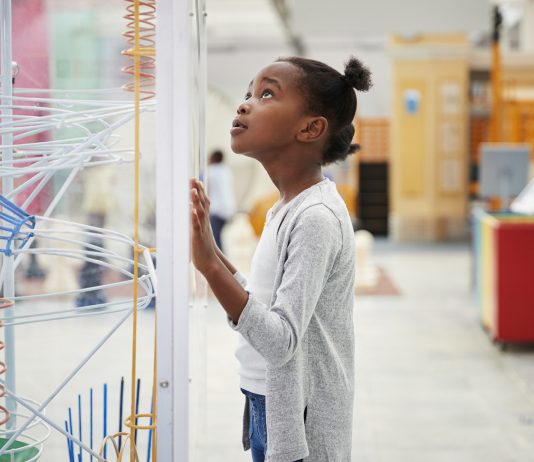 Young Girl Looking At Science Exhibit