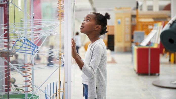 Young Girl Looking At Science Exhibit