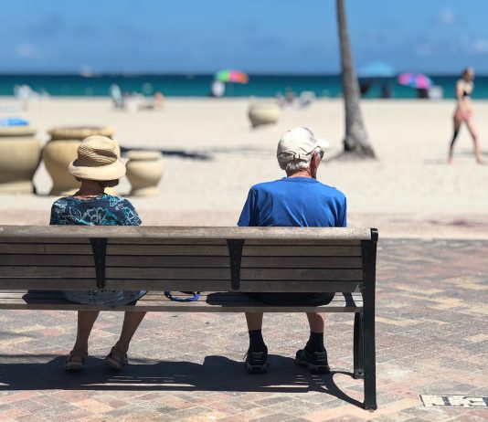 Adults on a beach bench