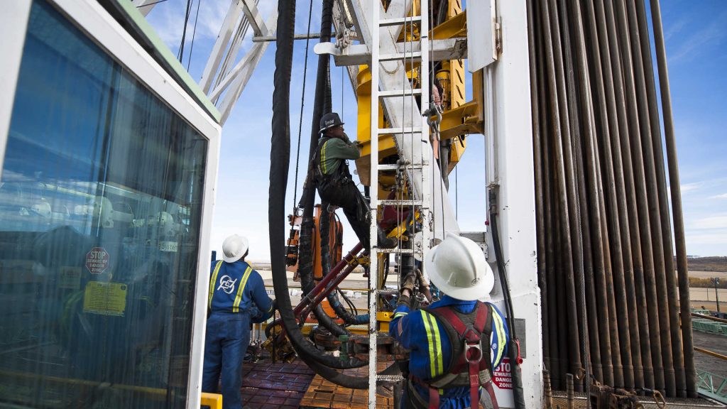 Oil Workers Climb a Rig