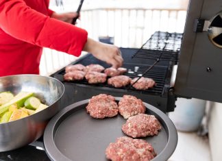 Woman Cooking Meat on Propane Barbecue Grill