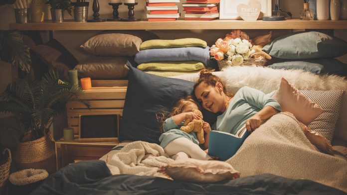 Mother reading a book to her daughter