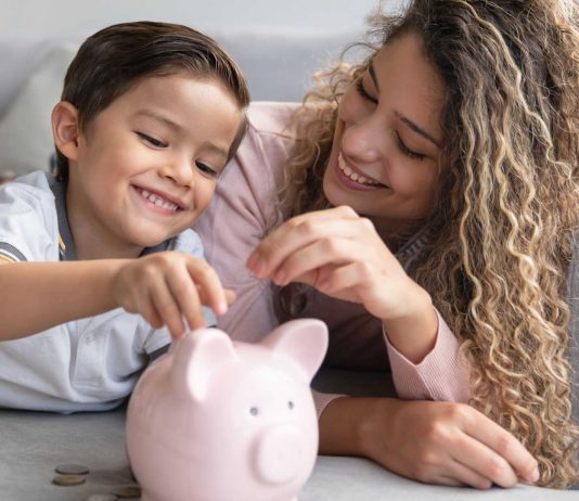 Mother and son saving money in a piggybank