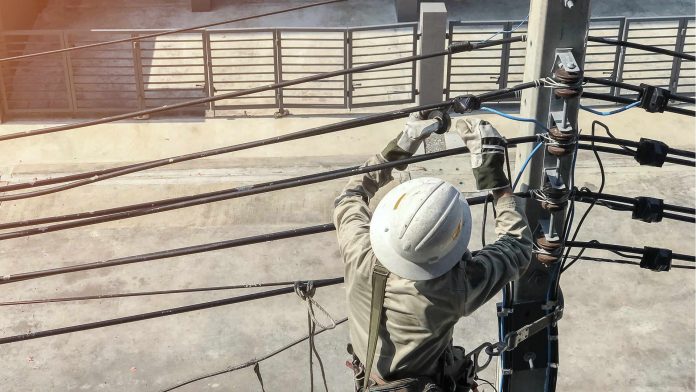 Electricians are climbing on electric poles utility