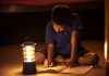 Child Doing Homework During Power Outage