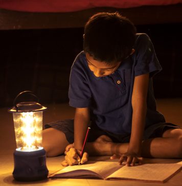 Child Doing Homework During Power Outage