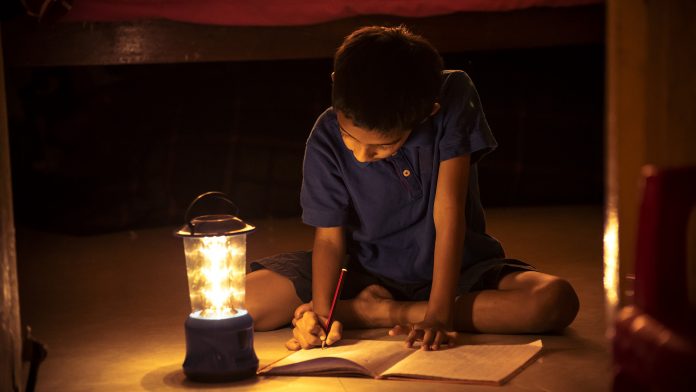 Child Doing Homework During Power Outage