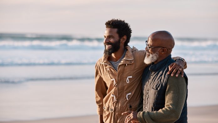 Father and son walking along the beach