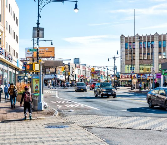 People crossing street in Fordham Heights center, New York City